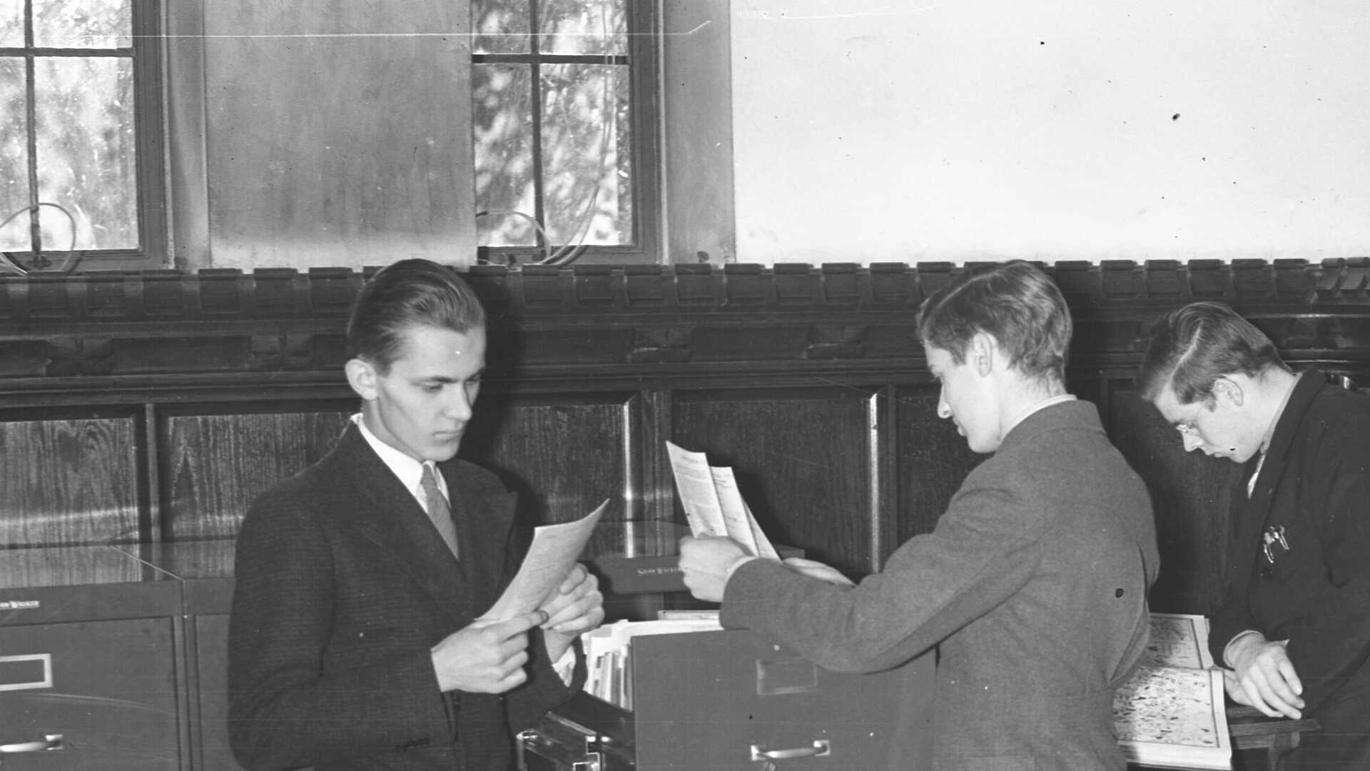 Archival photo of students using a vertical file