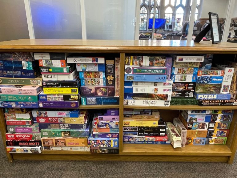 Short bookshelves filled with board games and books.