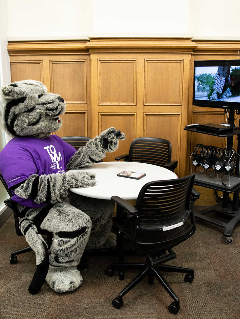 Tommie, St Thomas’ mascot, watches a movie in a media viewing room