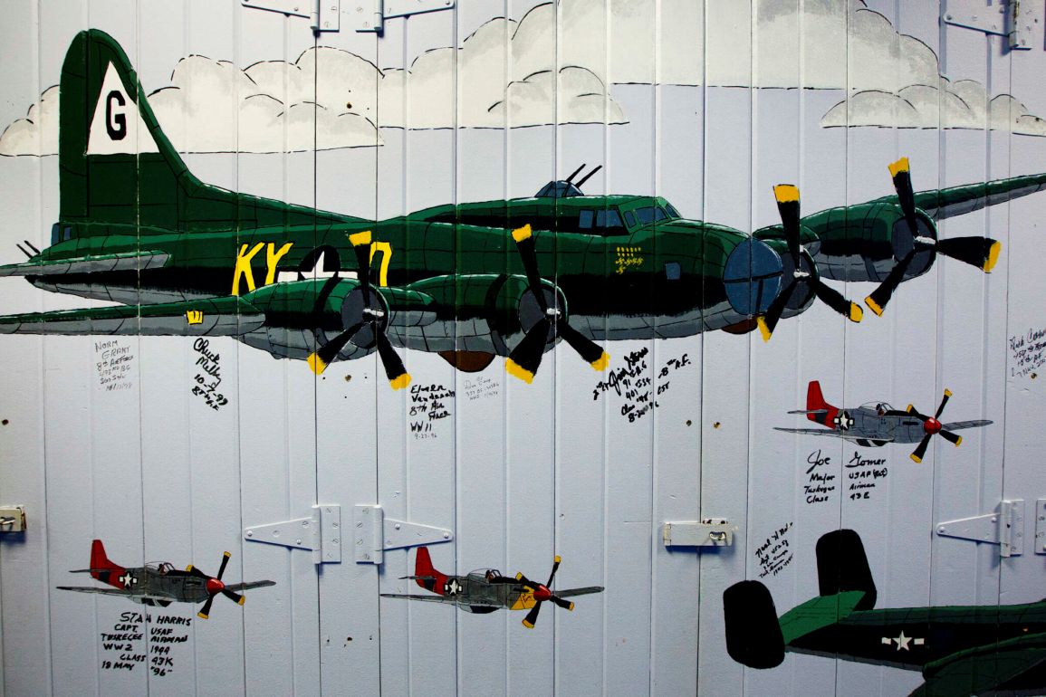 An Air Force ROTC mural painted on old doors features a B-17 Flying Fortress World War II bomber and P-51 Mustangs.