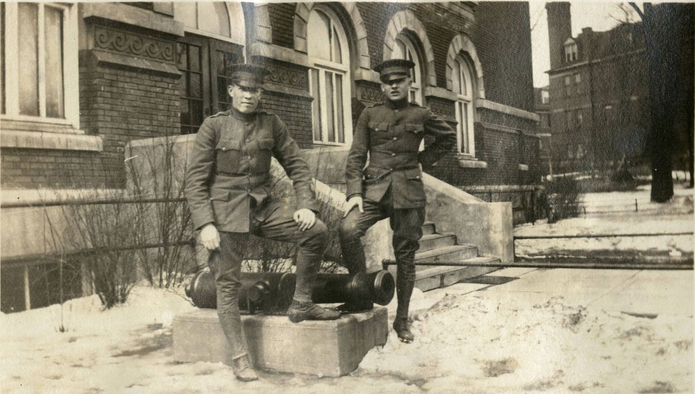 Two St. Thomas Military Academy students posed with a cannon outside of the Clubhouse (later Foley Theater) on the College of St. Thomas campus.
